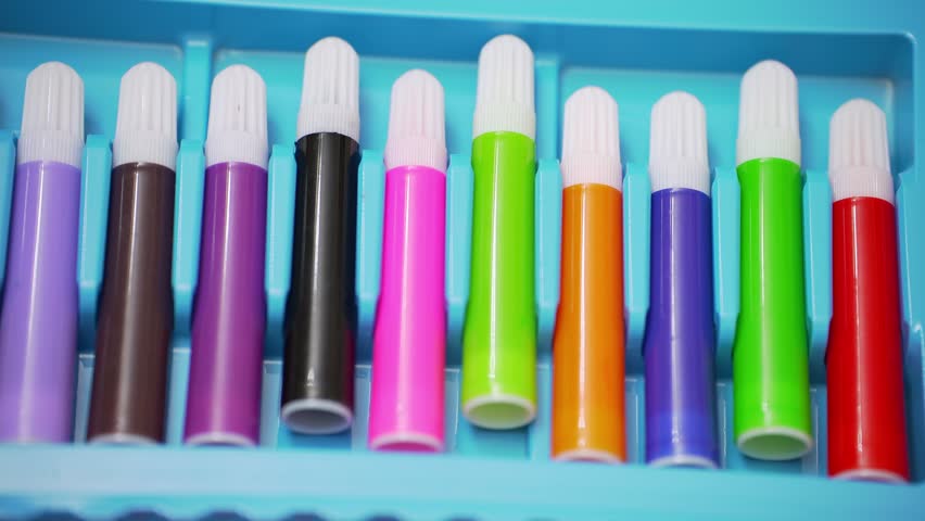 Large bright set of multi-colored felt-tip pens for drawing in a blue plastic box.