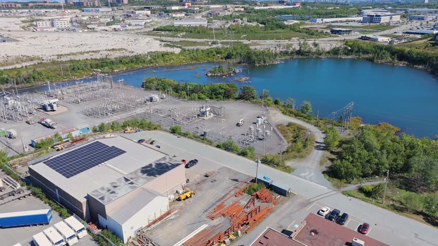 Aerial View Showing Industrial Power Station Near The Lake With High Voltage Lines And Substation Facilities Supplying Energy To Halifax Region. Lakefront Power Plant In Nova Scotia Canada
