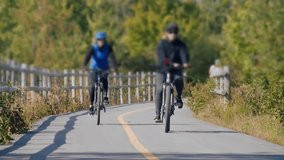 Cinematic Footage Of Female Cyclists Enjoying Leisure Ride Along A Bike Path Surrounded By Fall Foliage. - Powered by Shutterstock - Get 15% off with code: PIKWIZARD15