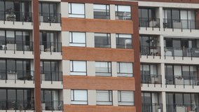 close up to a modern residential building windows with a morning rain into a latin american city - Powered by Shutterstock - Get 15% off with code: PIKWIZARD15