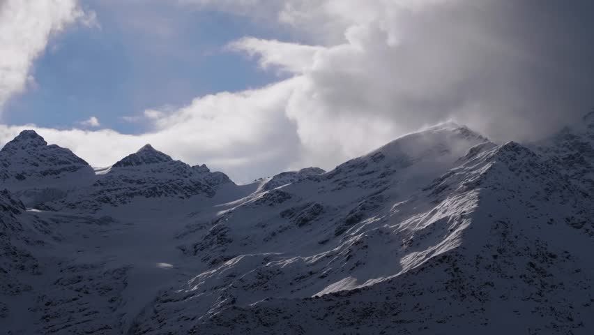 A majestic and dramatic view of the snow capped peaks of Mount Elbrus, the highest mountain in Russia and Europe, located in the North Caucasus region.