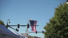 celebration with banners above lively street, community pride shown with national emblem in view, downtown area decorated with hanging flags during festive summer community gathering - Powered by Shutterstock - Get 15% off with code: PIKWIZARD15