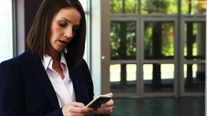 Businesswoman tapping phone near lobby, initiating AR network expanding around her while speaking. Smartphone, professional, augmented, overlay, connectivity, glass, foyer - Powered by Shutterstock - Get 15% off with code: PIKWIZARD15