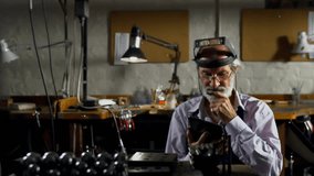 Senior man tapping tablet, initiating animated network icons filling workshop for tech analysis. Elderly, craftsman, bench, loupe, touchscreen, overlay, data - Powered by Shutterstock - Get 15% off with code: PIKWIZARD15