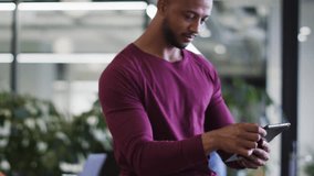 Male professional tapping device in modern business hub, activating AR HUD circles showing contacts. Office, smartphone, augmented, reality, overlay, interface, futuristic - Powered by Shutterstock - Get 15% off with code: PIKWIZARD15