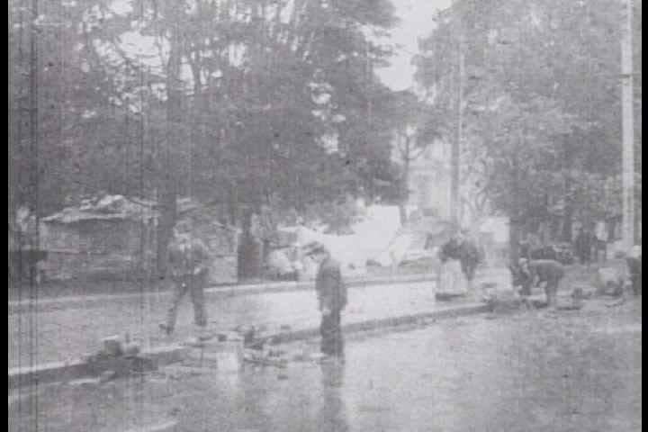 1900s - Survivors wait in line for services. Pan of San Francisco in ruins near City Hall.
