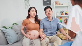 Asian young pregnant wife visit maternal health center with her husband. Attractive expectant couple consulting with doctor, receiving support and guidance during a prenatal checkup at the clinic. - Powered by Shutterstock - Get 15% off with code: PIKWIZARD15