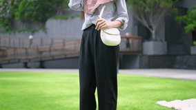 Asian Muslim woman enjoy music with headphones while standing in city. Attractive young girl wearing hijab feeling happy and relax while listen to songs outdoors, walking in the modern urban setting. - Powered by Shutterstock - Get 15% off with code: PIKWIZARD15