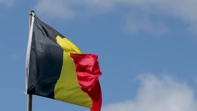 Belgium national flag ripples dynamically in daylight breeze, clear sky background, smooth camera tracking - Powered by Shutterstock - Get 15% off with code: PIKWIZARD15