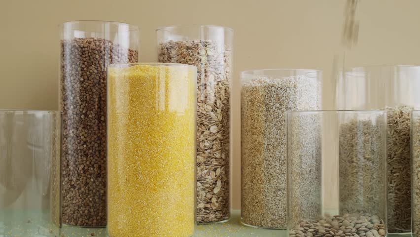 Set of Raw porridges in sustainable packaging. Refillable systems of packaging. Gluten free cereals. Health gut benefits. Concept of alternative whole spelt grain ingredient. Vegetarian diet recipes