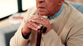 Walking stick, thinking and hands of senior man on sofa for reflection, nostalgia and memory in home. Retirement, living room and elderly person with disability and cane for remember, lonely and sad - Powered by Shutterstock - Get 15% off with code: PIKWIZARD15