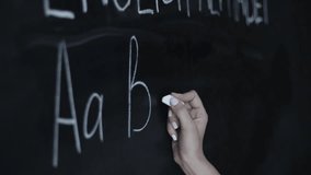 Teacher writing ABC alphabet on a school blackboard, illustrating early education, learning, preschool teaching, and classroom learning activities. - Powered by Shutterstock - Get 15% off with code: PIKWIZARD15
