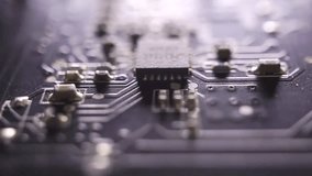 An extreme close-up dolly shot of a circuit board highlighting electronic components, microchips, and intricate pathways that showcase modern technology and precision engineering. - Powered by Shutterstock - Get 15% off with code: PIKWIZARD15