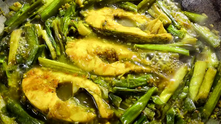 Cooking Chinese celery  with fish in pan, indoor Chiangmai Thailand.