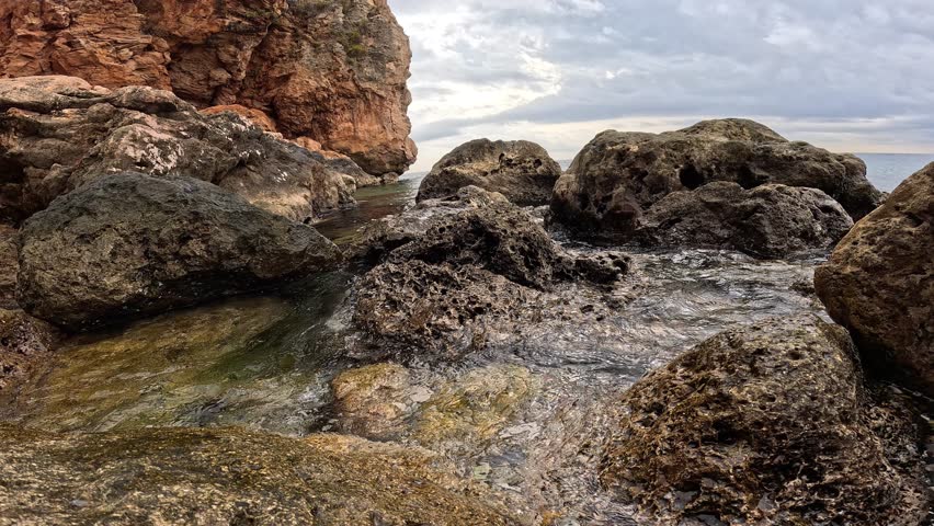 scenic coastal landscape with waves and stones