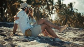 Happy Couple Sitting On Tropical Beach Under Palm Trees, Romantic Summer Holiday Getaway. Man And Woman Relaxing By Ocean, Honeymoon Destination And Travel. Drinking Coconut Water, Luxury Vacation - Powered by Shutterstock - Get 15% off with code: PIKWIZARD15