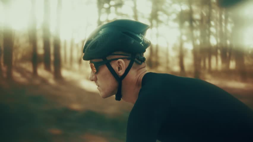 Cyclist Riding Road Bike, Dynamic  Athlete. Professional Cycling Training Outdoors, Endurance Sport And Fitness Challenge, Man In Black Cycling Gear, Race Bike Action. Performance Training Cycling