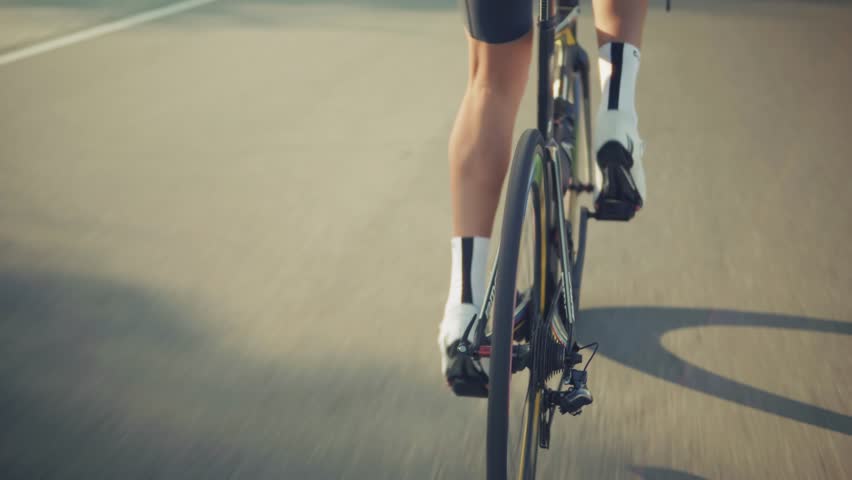 Cyclist Riding Road Bike, Dynamic  Athlete. Professional Cycling Training Outdoors, Endurance Sport And Fitness Challenge, Man In Black Cycling Gear, Race Bike Action. Performance Training Cycling