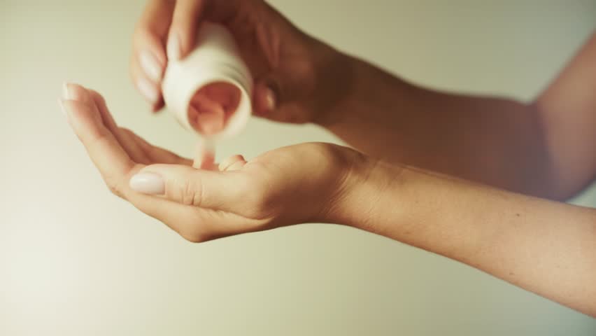Dispensing Pills From Bottle Into Hand, Taking Daily Medication Or Supplements. Health And Wellness. Hands Holding Medical Tablets, Taking Prescription Drugs, Vitamin Dosage. Pharmaceutical Treatment