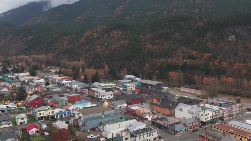 Descending and panning aerial shot of historic Skagway, Alaska in the fall season. 4K