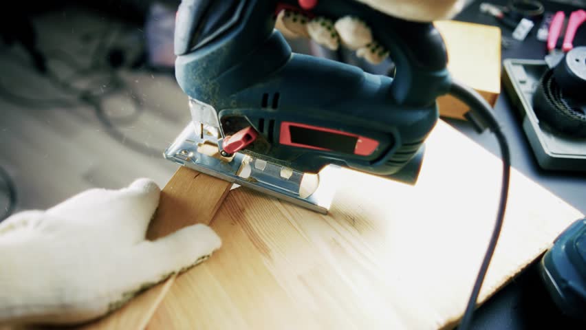 Jigsaw Cutting Wooden Plank, Power Tool And Carpentry Work, Woodworking Hobby Or Professional Trade. Electric Saw Blade In Action, Making Precise Cuts In Wood, DIY Home Renovation And Craftsmanship