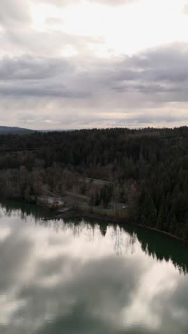 Aerial View of Serene Forest Lake Reflecting Cloudy Skies in British Columbia, Canada