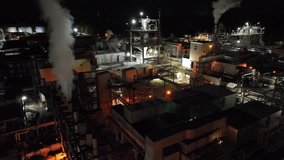 Aerial night view of a large American industrial plant with illuminated structures, steam, metal pipelines and factory buildings operating at night. DuPont factory in Richmond,Virginia. - Powered by Shutterstock - Get 15% off with code: PIKWIZARD15
