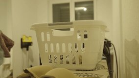 A man sorts and does laundry at home, showing daily household chores and cleanliness. - Powered by Shutterstock - Get 15% off with code: PIKWIZARD15