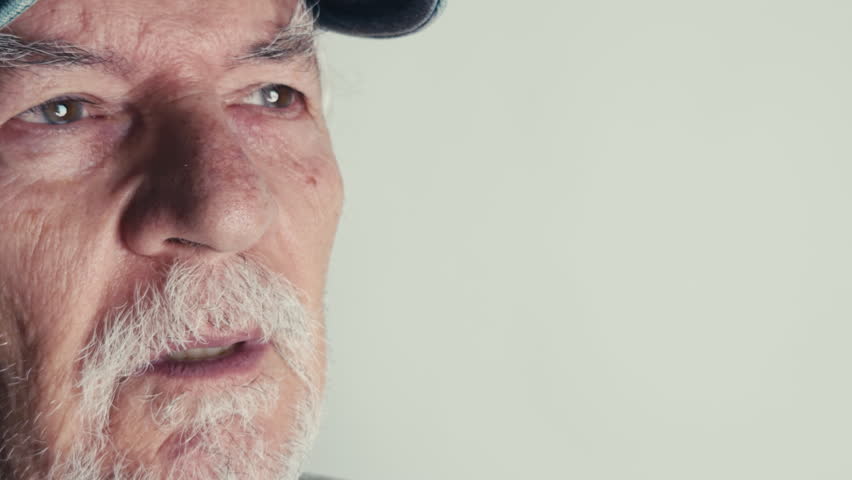 Senior Old Man Rubs His Eyes in Discomfort