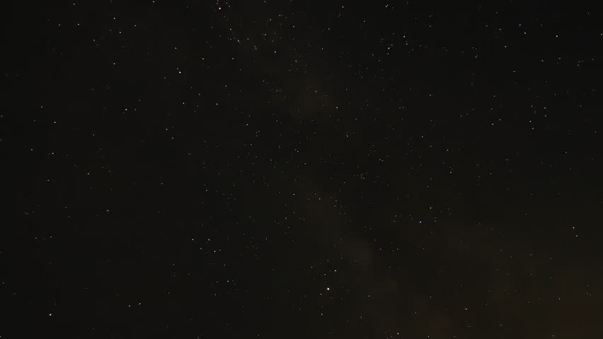 Large StarField with Satellites Passing Over Night Sky with Faint Milky Way Galactic Center. Points of Light in the Sky with Meteors and Man Made Objects. Natural Dark Sky Timelapse.