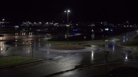 A view of cars passing and reflecting lights on wet asphalt on a rainy night near the commercial district of Loekkemyra in Kristiansund, Norway - Powered by Shutterstock - Get 15% off with code: PIKWIZARD15