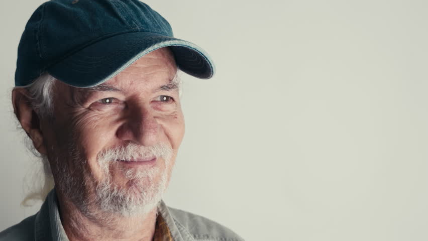 Elderly Old Man Wearing a Hat Taking a Photo With Camera