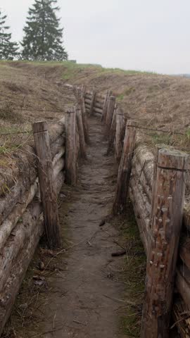 A first-person view of movement through a military trench at a fortification in Ukraine or Russia slow motion 4k