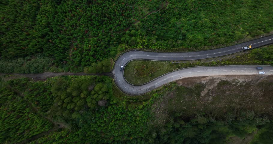 A top down aerial footage of a twist mountain road near Lagoa Azul (Blue Lagoon) during daytime in Sao Miguel island, the Azores, Portugal