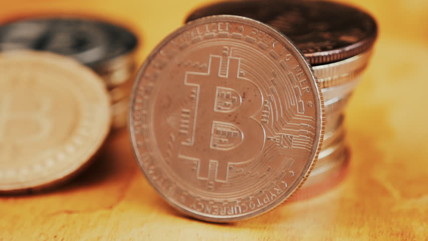 Close up of shiny physical Bitcoin coins stacked on a table