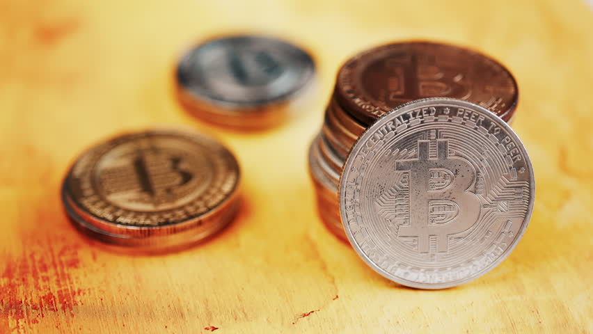 Close up of shiny physical Bitcoin coins stacked on a table