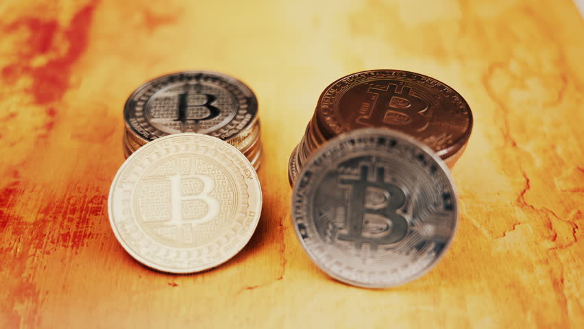 Close up of shiny physical Bitcoin coins stacked on a table