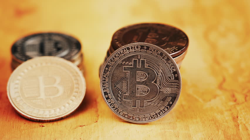 Close up of shiny physical Bitcoin coins stacked on a table