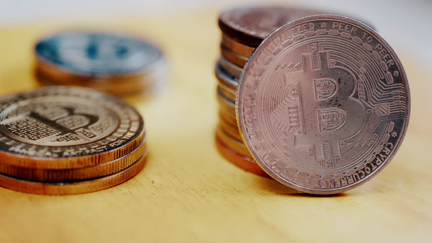 Close up of shiny physical Bitcoin coins stacked on a table