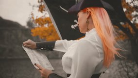 Back rear view fantasy woman captain pirate holding in hands map searching for treasure. silhouette person looking for wealth. girl thief game old style. black pirate flag fly flutters in wind blow 4k - Powered by Shutterstock - Get 15% off with code: PIKWIZARD15