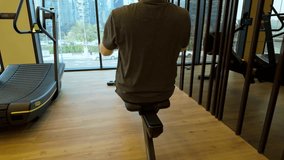 Behind Shot Of A Man Working Out In A Indoor Gymnasium On A Rowing Machine For Health And Wellbeing. - Powered by Shutterstock - Get 15% off with code: PIKWIZARD15