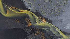 Aerial view of stunning braided river with yellow and dark color tones flowing through the landscape, creating intricate patterns, Grindavikurbaer, Iceland. - Powered by Shutterstock - Get 15% off with code: PIKWIZARD15