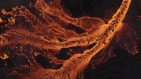 Aerial view of molten lava snaking through the dark landscape, a fiery river contrasting dramatically with the cool, solid earth, Reykjanes, Grindavikurbaer, Iceland. - Powered by Shutterstock - Get 15% off with code: PIKWIZARD15