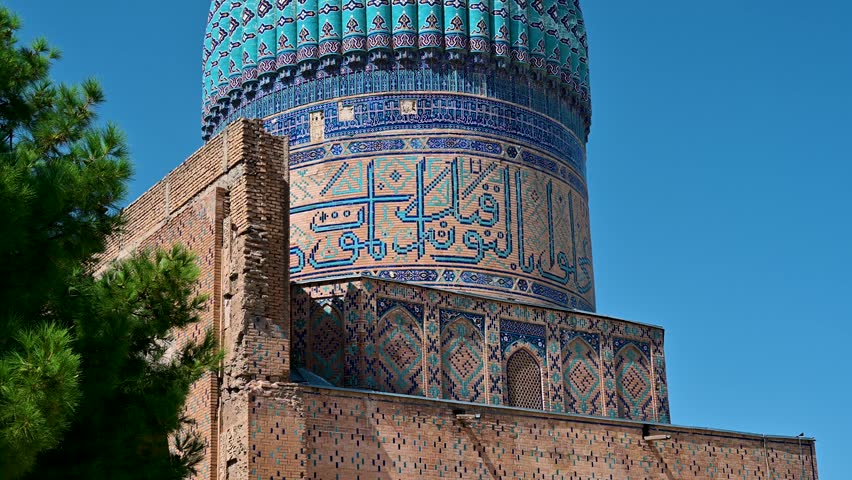 Wide shot of the blue dome of Bibi Khanym Mosque in Samarkand, Uzbekistan, showing intricate Islamic tilework and historic architecture.