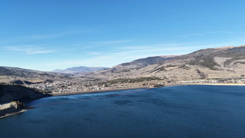 Curling drone shot of Silverthorne, Colorado from above the Dillon Reservoir-Dam