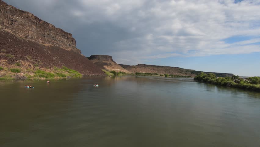 Aerial footage of the Snake River and basalt cliffs near Blue Heart Springs in Idaho. Perfect for travel, nature, and landscape projects.