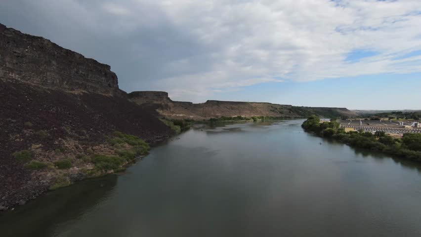 Scenic aerial footage of Idaho’s Snake River corridor near Blue Heart Springs, showing rugged cliffs and calm water.