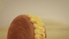 Close-up shot of a rolled pastry topped with mango cream, smooth camera movement highlighting the texture and glossy topping, dessert food footage - Powered by Shutterstock - Get 15% off with code: PIKWIZARD15