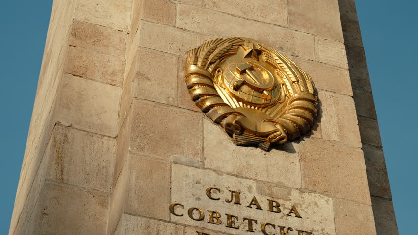 Detailed close-up of the hammer-and-sickle emblem on a Soviet war memorial in Budapest, symbolizing Red Army history, USSR presence, and Cold War heritage.