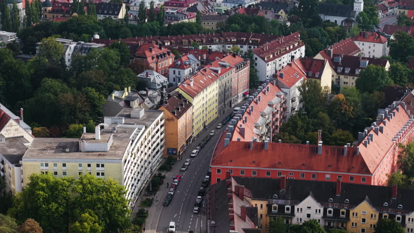 Telephoto drone shot around traffic on the streets of Munich, in sunny Germany